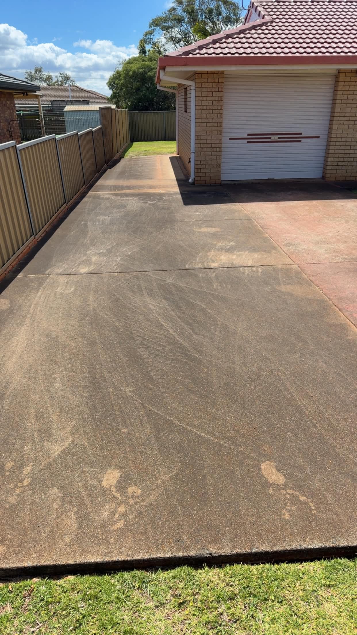 Dirty concrete driveway before cleaning